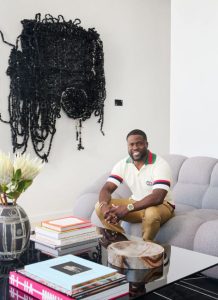 Hart sits on the Roche Bobois Perspective sofa he compares to a catcher’s mitt, in front of a piece by Moffat Takadiwa called Found Black Keys.