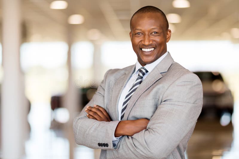 african car sales consultant arms folded showroom 67664169